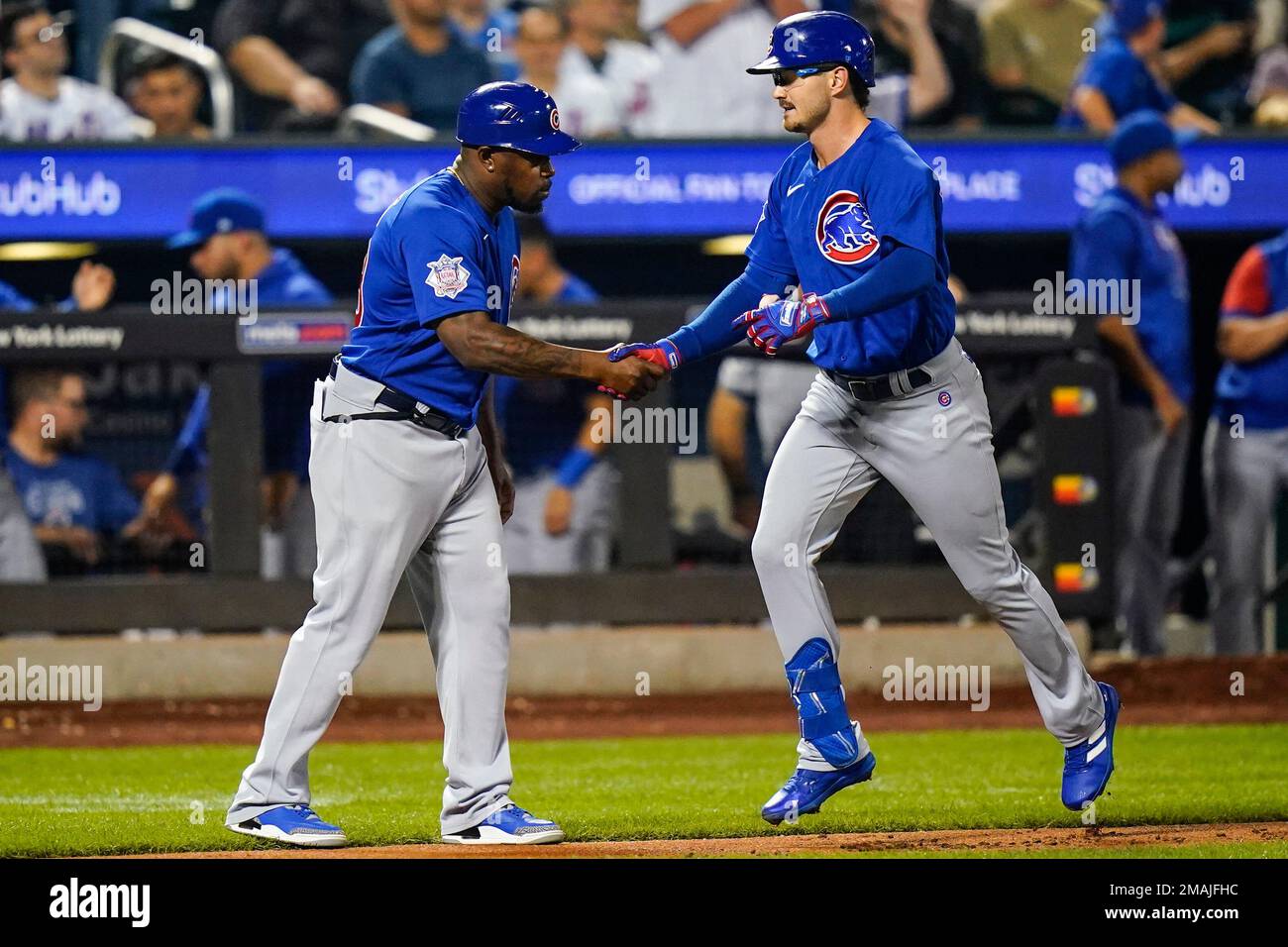 Chicago Cubs' Zach McKinstry celebrates with third base coach