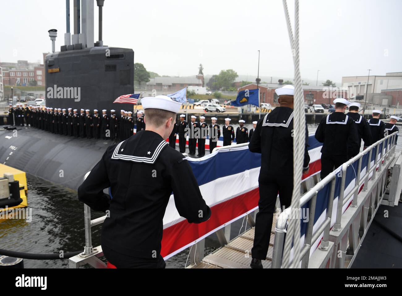 220528-N-GR655-0152 GROTON, Connecticut (May 28, 2022) – Crewmembers attached to the Virginia-class fast attack submarine USS Oregon (SSN 793) run aboard to “bring the ship to life” during a commissioning ceremony in Groton, Conn., May 28, 2022. SSN 793, the third U.S Navy ship launched with the name Oregon and first in more than a century, is a flexible, multi-mission platform designed to carry out the seven core competencies of the submarine force: anti-submarine warfare; anti-surface warfare; delivery of special operations forces; strike warfare; irregular warfare; intelligence, surveillanc Stock Photo