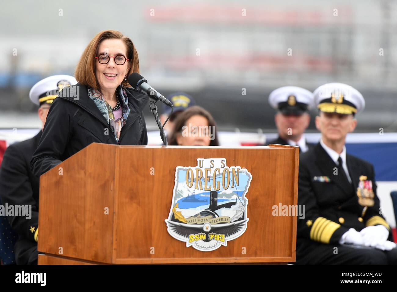 220528-N-GR655-0097 GROTON, Connecticut (May 28, 2022) – Gov. Kate Brown of Oregon delivers remarks during a commissioning ceremony for the Virginia-class fast attack submarine USS Oregon (SSN 793) in Groton, Conn., May 28, 2022. SSN 793, the third U.S Navy ship launched with the name Oregon and first in more than a century, is a flexible, multi-mission platform designed to carry out the seven core competencies of the submarine force: anti-submarine warfare; anti-surface warfare; delivery of special operations forces; strike warfare; irregular warfare; intelligence, surveillance and reconnaiss Stock Photo
