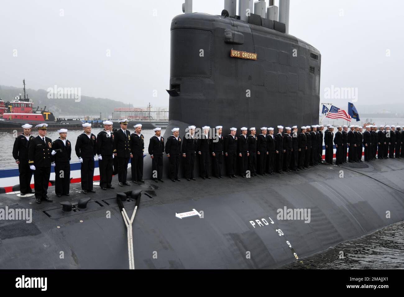 220528-N-GR655-0202 GROTON, Connecticut (May 28, 2022) – Crewmembers attached to the Virginia-class fast attack submarine USS Oregon (SSN 793) man the ship during a commissioning ceremony in Groton, Conn., May 28, 2022. SSN 793, the third U.S Navy ship launched with the name Oregon and first in more than a century, is a flexible, multi-mission platform designed to carry out the seven core competencies of the submarine force: anti-submarine warfare; anti-surface warfare; delivery of special operations forces; strike warfare; irregular warfare; intelligence, surveillance and reconnaissance; and Stock Photo