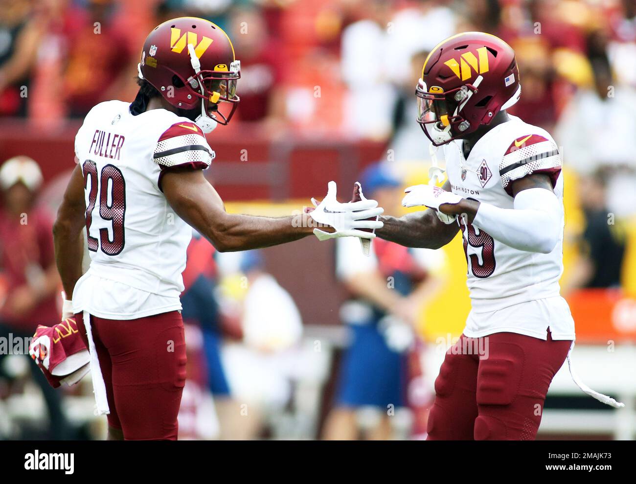Washington Commanders cornerback Kendall Fuller (29) and Washington  Commanders safety Jeremy Reaves (39) celebrate before an