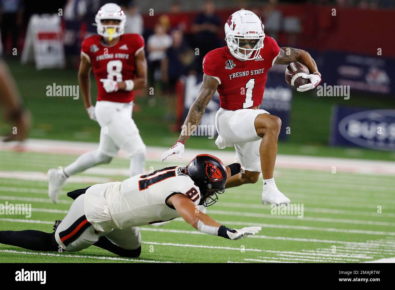 Fresno State wide receiver Nikko Remigio leaps over Oregon State's Jake