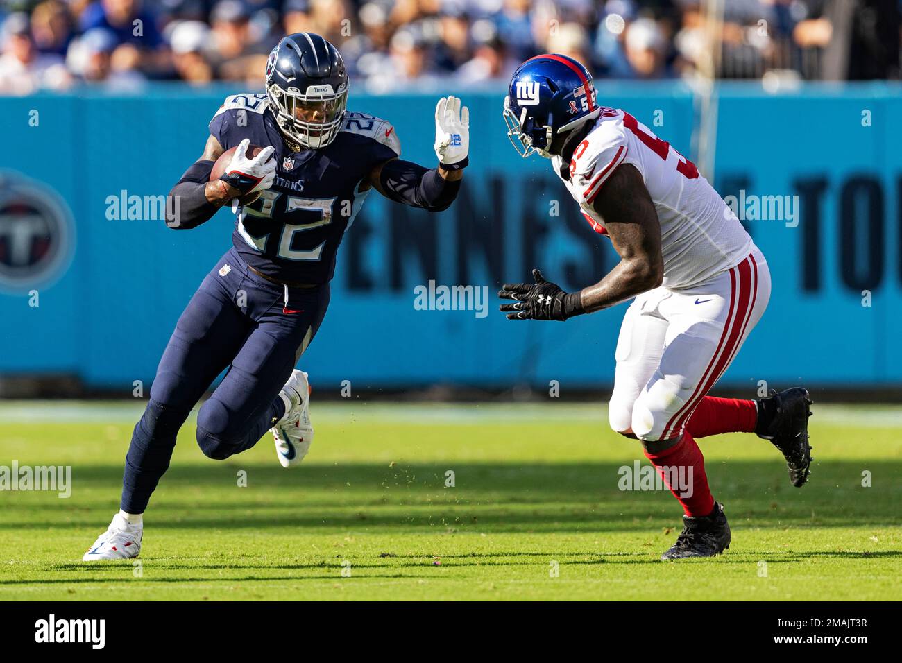 Tennessee Titans running back Derrick Henry (22) runs for yardage as hes chased by New York