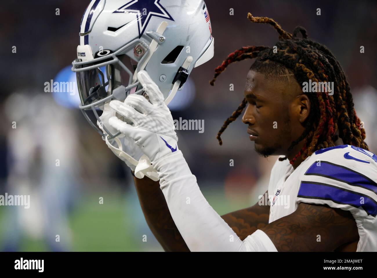 Dallas Cowboys wide receiver CeeDee Lamb (88) is seen with red, white and  blue strips on his helmet in honor of Salute to Service during warms up  before an NFL football game