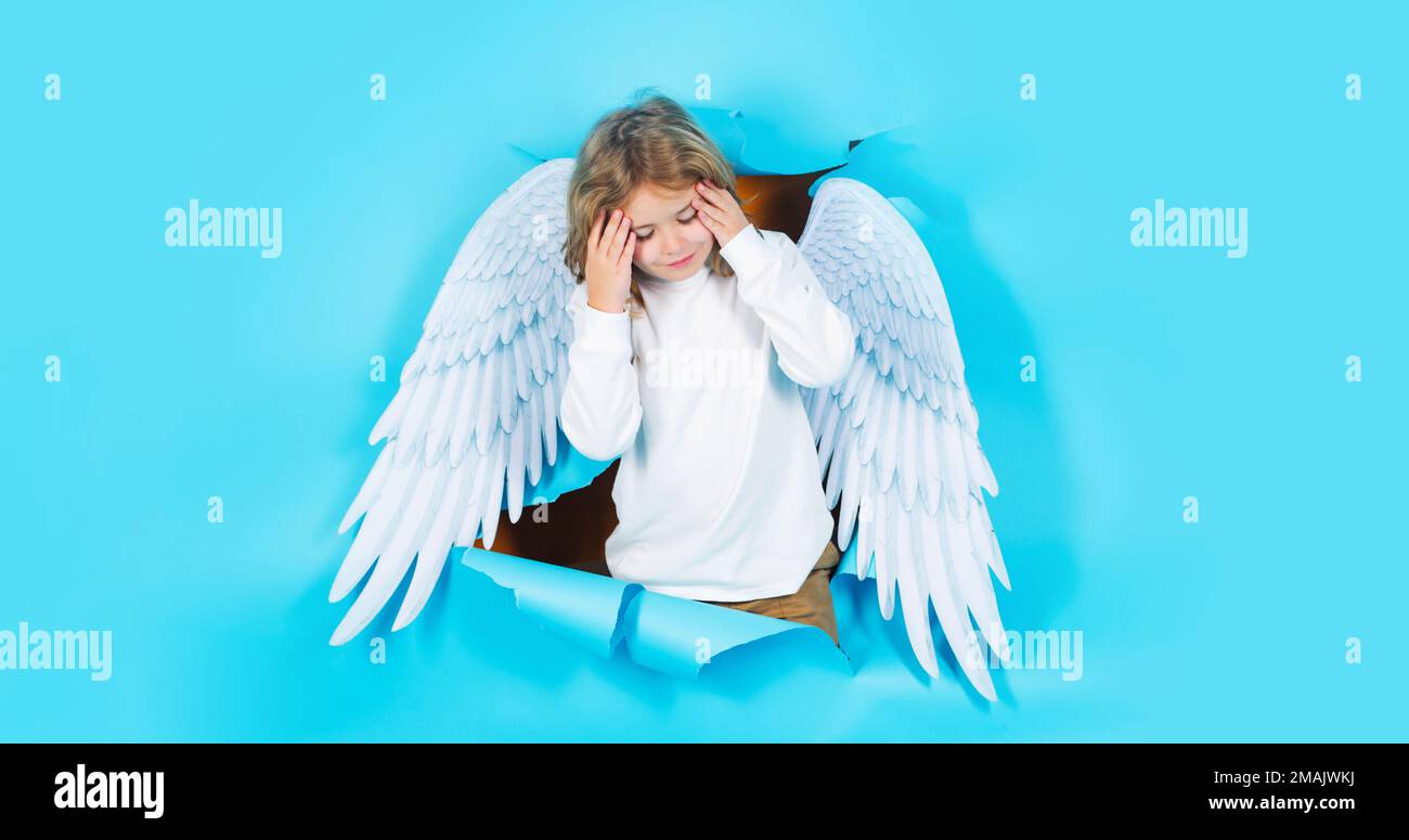 Valentines day. Blonde cute child in angel wings. Cupid boy. Angelic kid in paper hole. Banner. Stock Photo