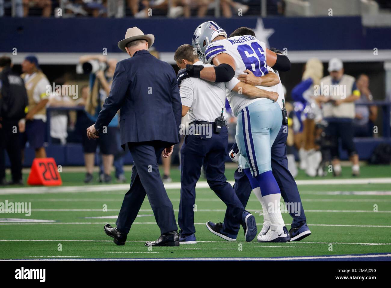 Dallas Cowboys guard Connor McGovern (66) is helped off the field by team  medical staff after suffering an unknown injury in the first half of a NFL  football game against the Tampa