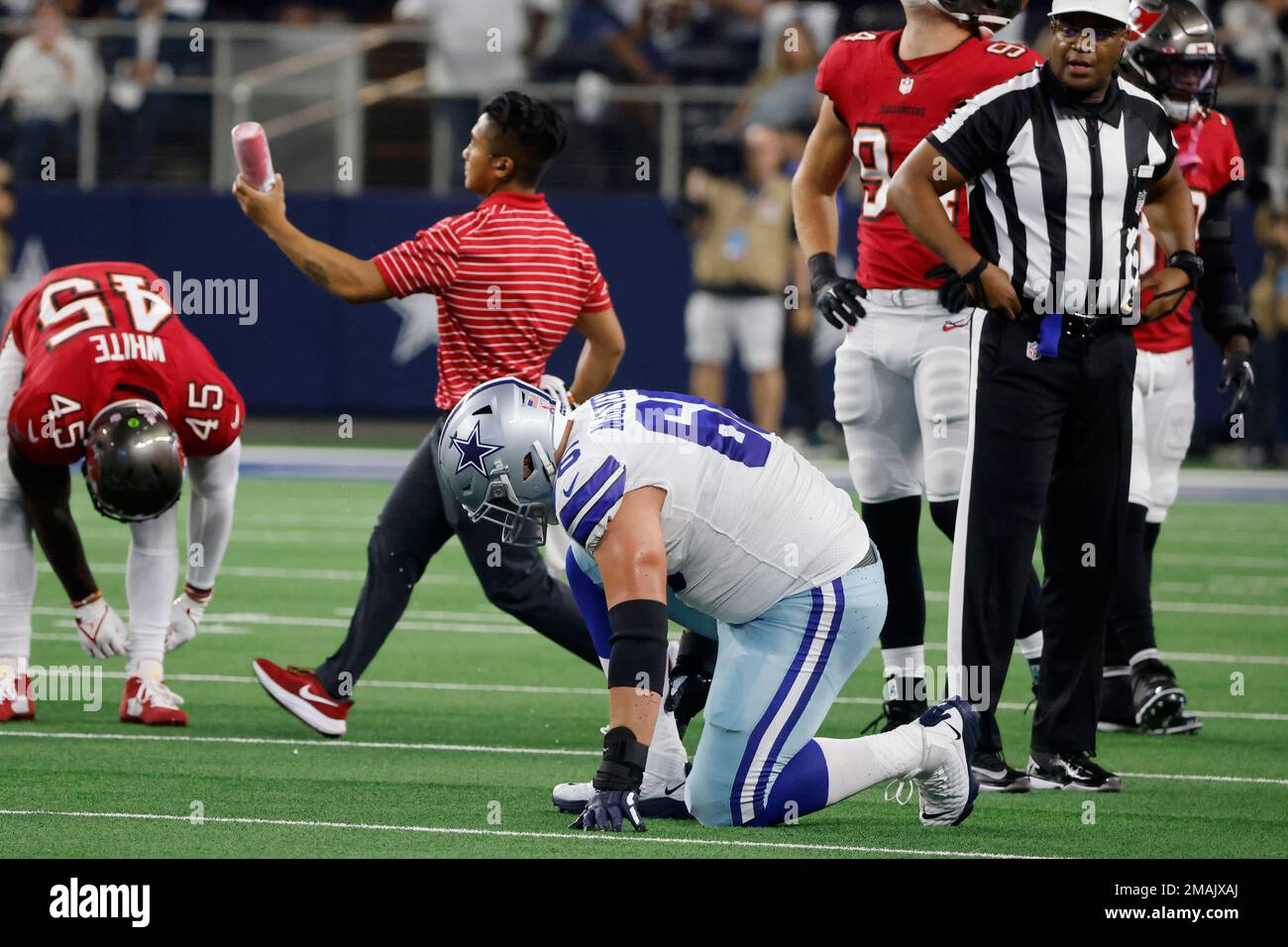 Dallas Cowboys guard Connor McGovern (66) is assisted off the field by  medical staff after suffering an unknown injury in the first half of a NFL  football game against the Tampa Bay