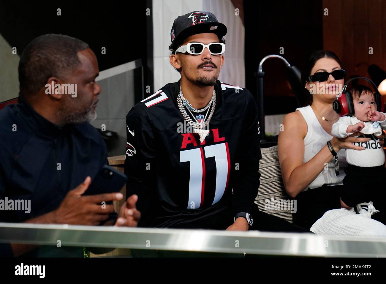 Atlanta Hawks NBA basketball player Trae Young watches play between the Atlanta  Falcons and the New Orleans Saints during the first half of an NFL football  game, Sunday, Sept. 11, 2022, in