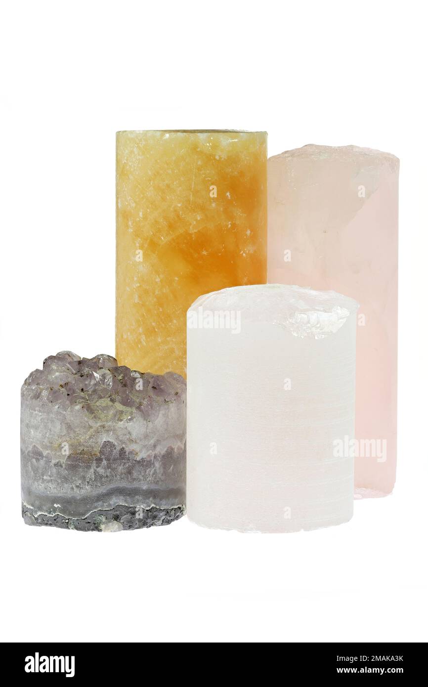 group of different drill cores isolated on white background (amethyst, rock crystal, orange calcite and rose quartz) Stock Photo