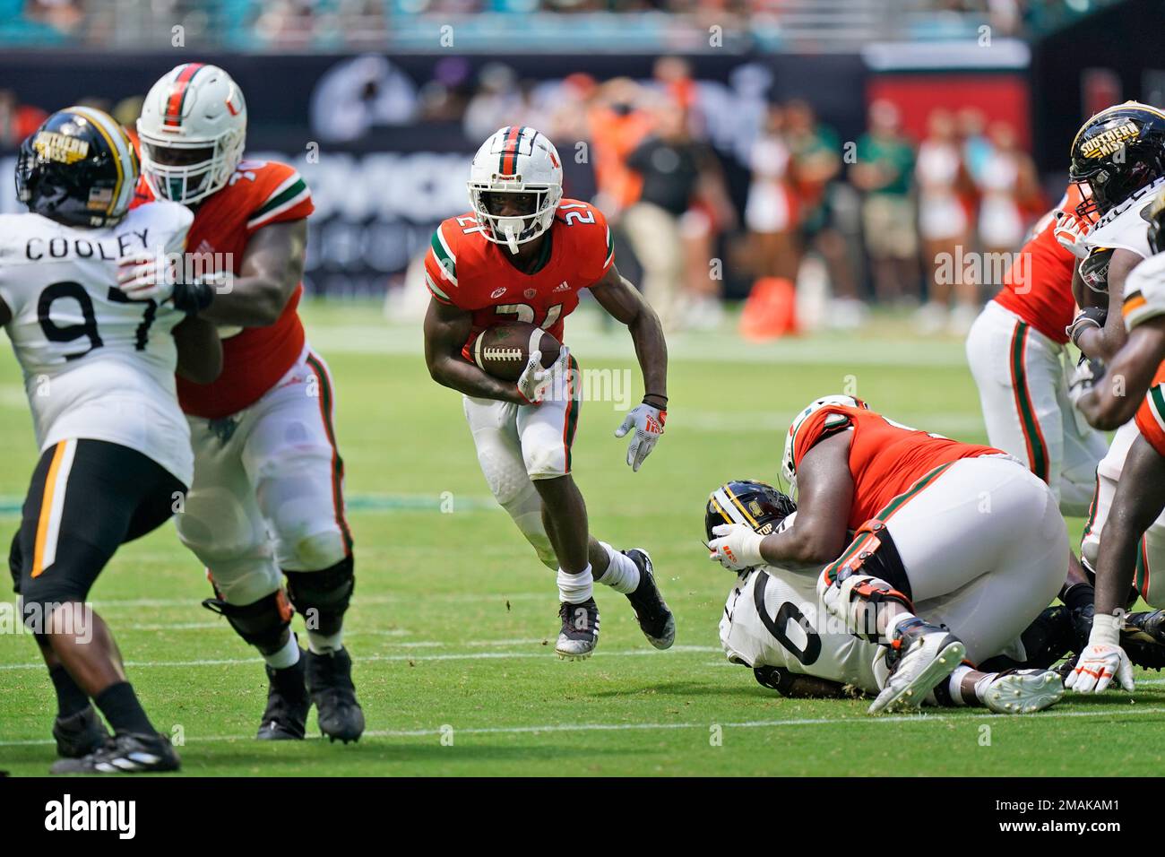 Miami running back Henry Parrish Jr. (21) runs the ball during the
