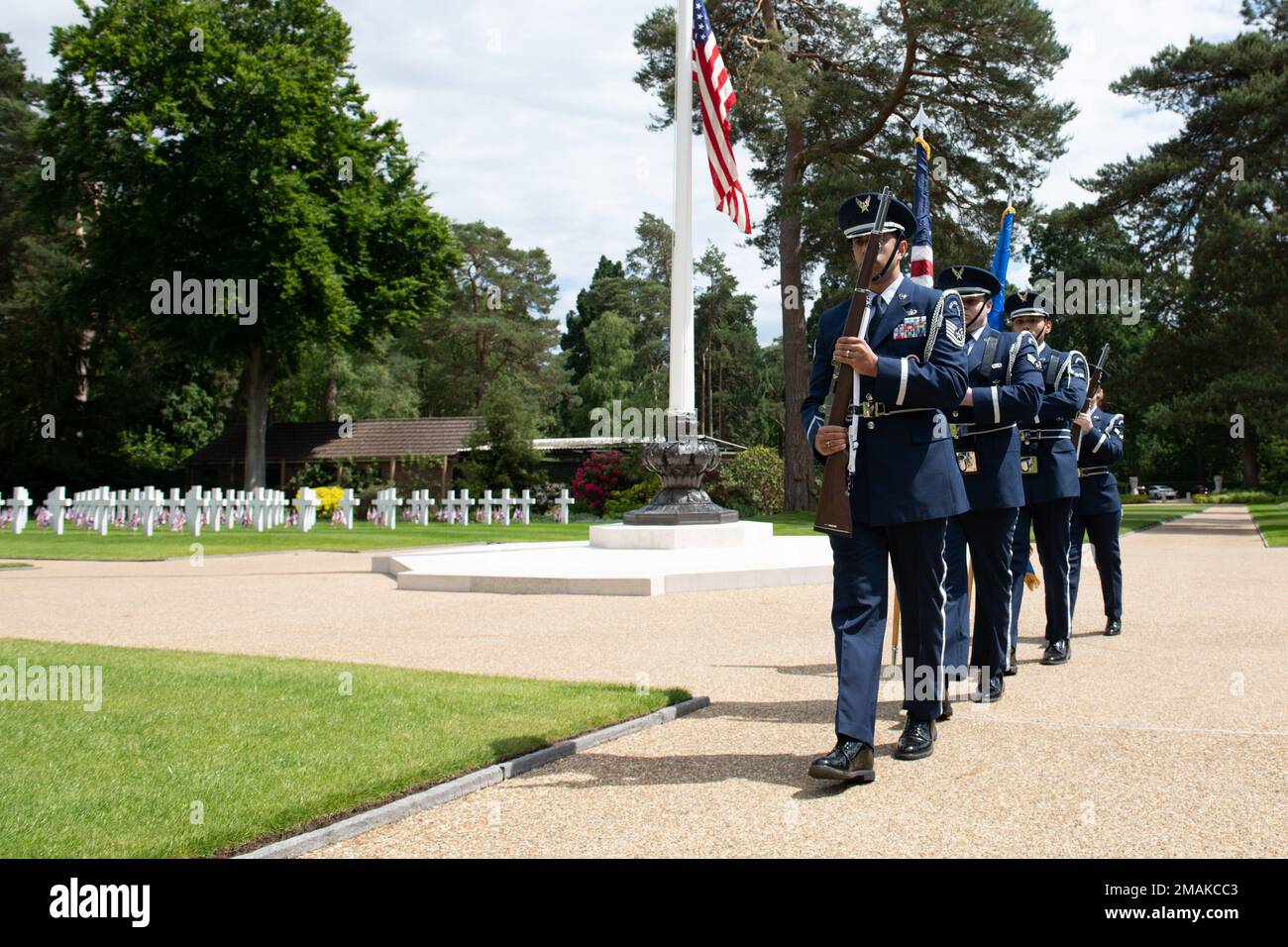U.S. Air Force Honor Guard from Royal Air Force Croughton prepares to present the colors during a Memorial Day ceremony at the Brookwood American Military Cemetery, England, May 29, 2022. Memorial Day provides us a solemn opportunity to remember our fallen brothers and sisters in arms, reflect upon their courageous sacrifice, and show gratitude for the freedom they gave their lives to defend. It also affords us the opportunity to pay homage to those families who lost their loved ones in service to the Nation-and continue to feel the full weight of that sacrifice today. Stock Photo