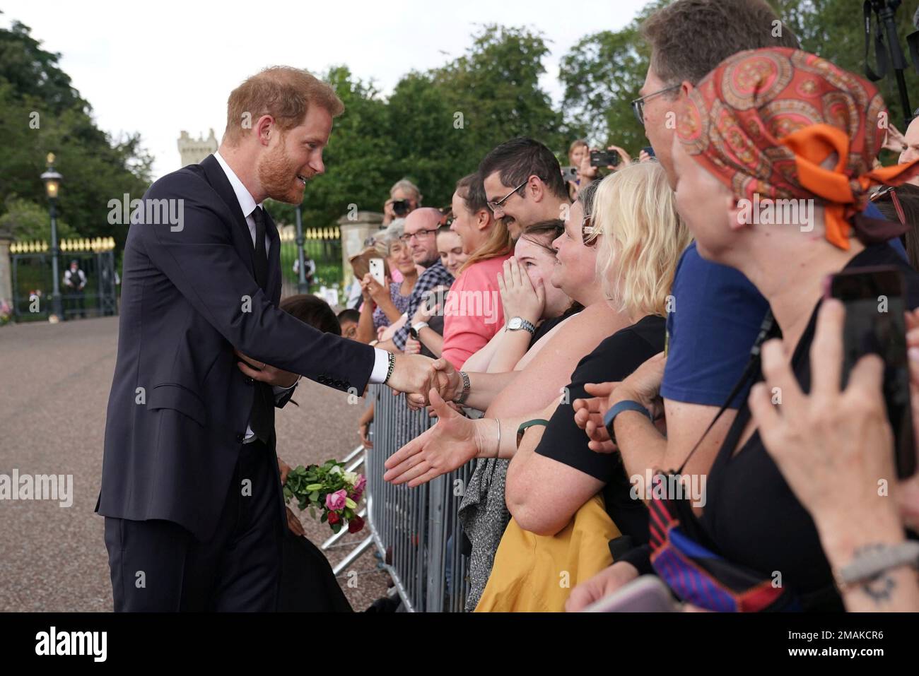 Britain's Prince Harry meets members of the public on a walkabout at(01)