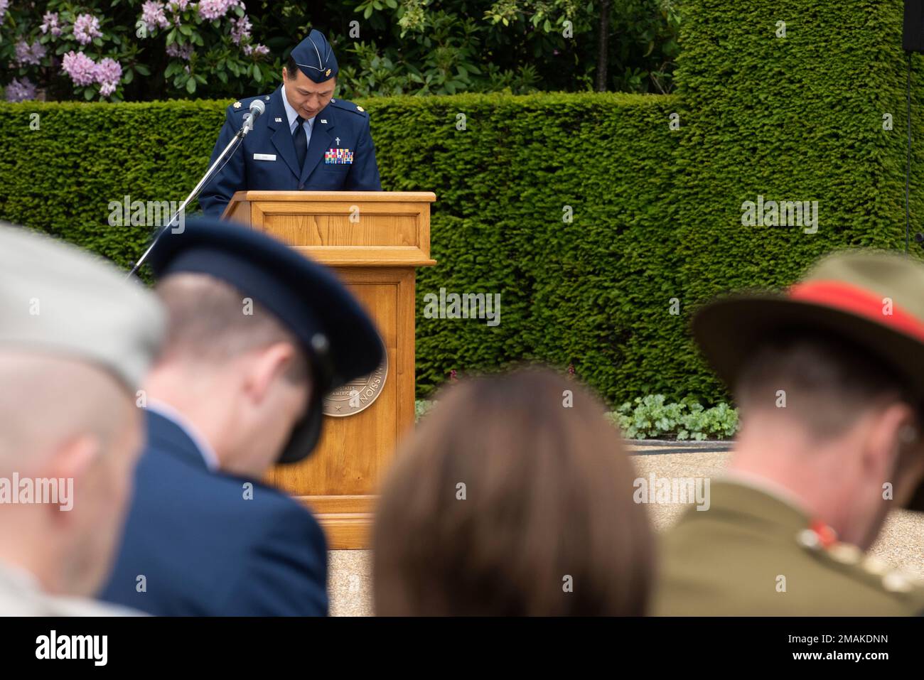 U.S. Air Force Chaplain Maj. Myung Cho, 501st Combat Support Wing deputy wing chaplain, leads an invocation during a Memorial Day ceremony at the Brookwood American Cemetery, England, May 29, 2022. Memorial Day provides us a solemn opportunity to remember our fallen brothers and sisters in arms, reflect upon their courageous sacrifice, and show gratitude for the freedom they gave their lives to defend. It also affords us the opportunity to pay homage to those families who lost their loved ones in service to the Nation-and continue to feel the full weight of that sacrifice today. Stock Photo