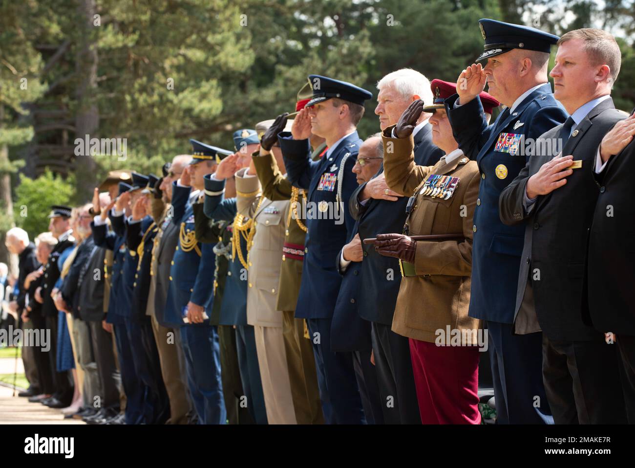 Armed Forces and guests stand for the U.S. national anthem at a Memorial Day ceremony at the Brookwood American Military Cemetery, England, May 29, 2022. Memorial Day provides us a solemn opportunity to remember our fallen brothers and sisters in arms, reflect upon their courageous sacrifice, and show gratitude for the freedom they gave their lives to defend. It also affords us the opportunity to pay homage to those families who lost their loved ones in service to the Nation-and continue to feel the full weight of that sacrifice today. Stock Photo