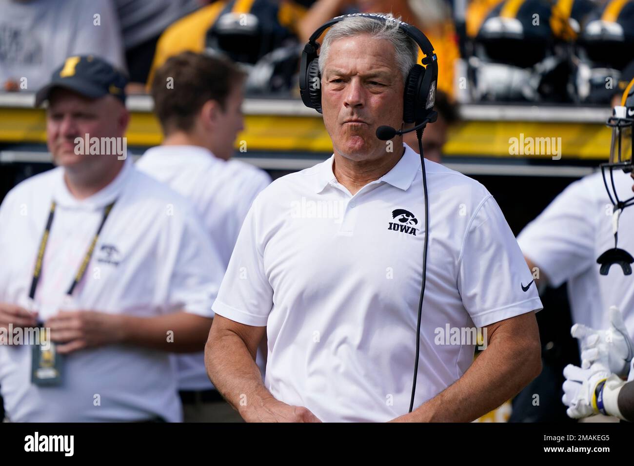 Iowa head coach Kirk Ferentz stands on the field before an NCAA college