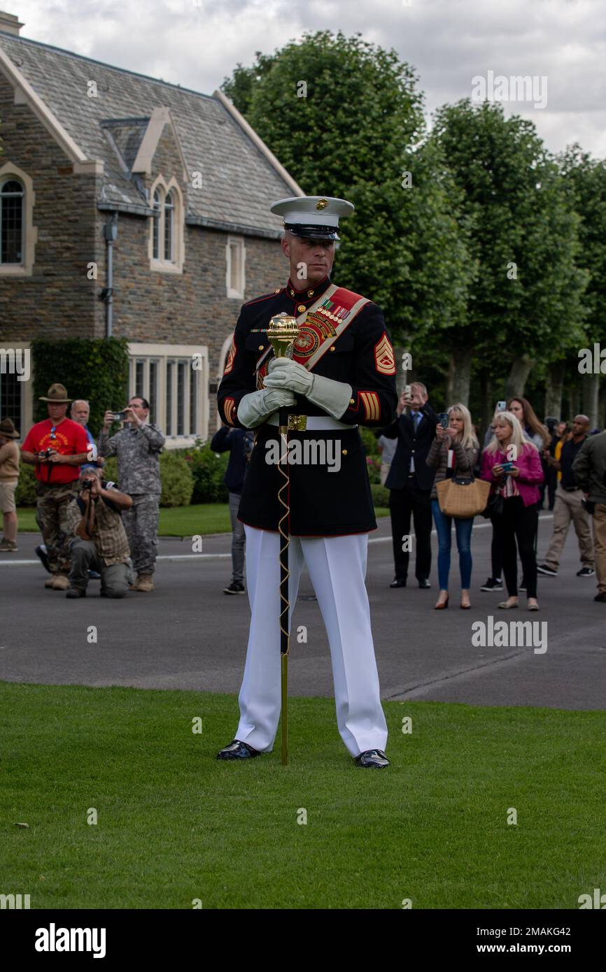U.S. Marine Corps Gunnery Sgt. Bryan Williams, the Drum Major with the 2d Marine Division Band leads the band during a ceremony at Aisne-Marne American Cemetery, Belleau, France, May 29, 2022. This Memorial Day ceremony was held to commemorate the 104th anniversary of the Battle of Belleau Wood. The visit is to honor those who made the ultimate sacrifice for their respective countries during World War I. Stock Photo