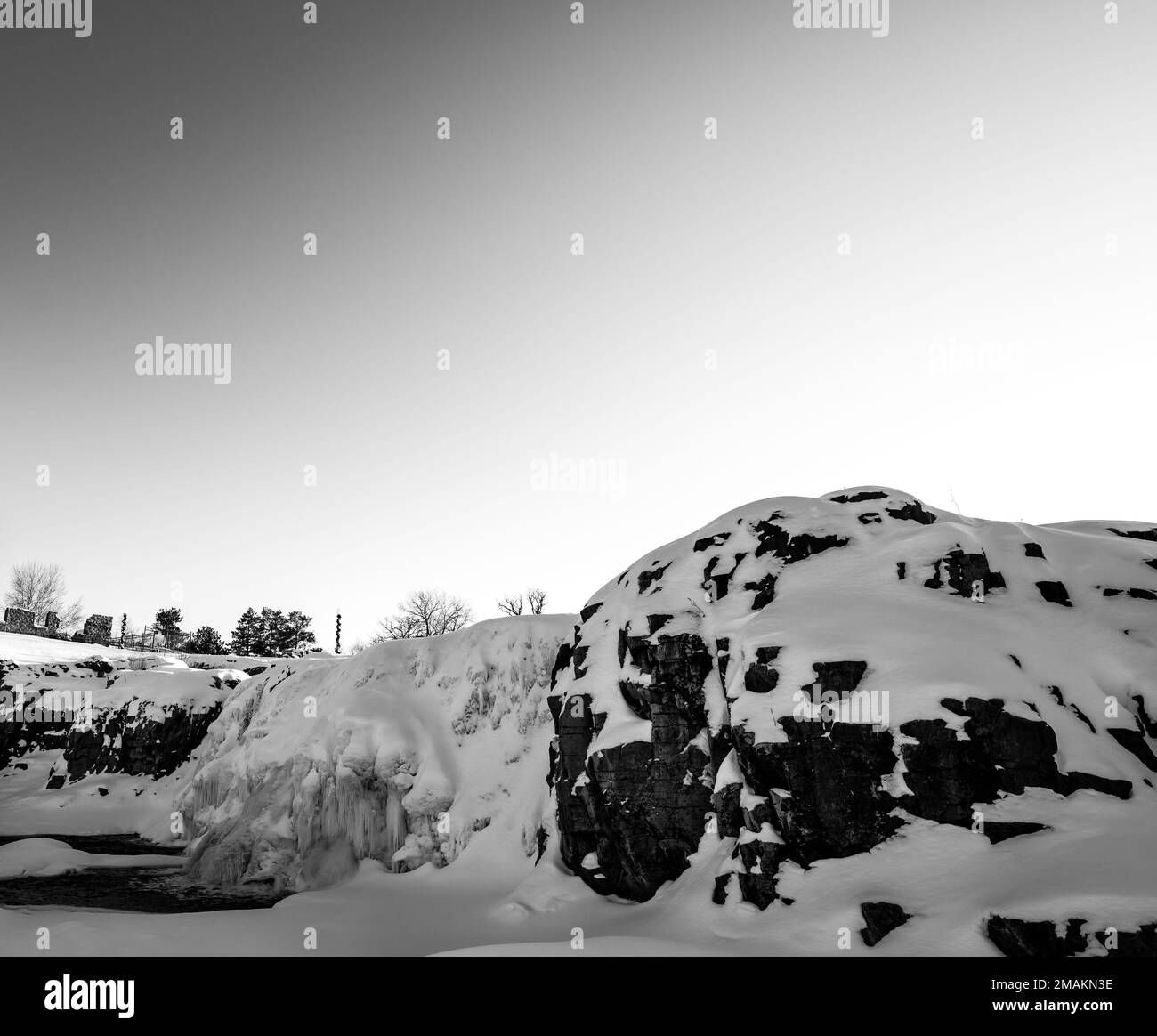 Sioux Falls Park during winter with frozen waterfall and snow cover