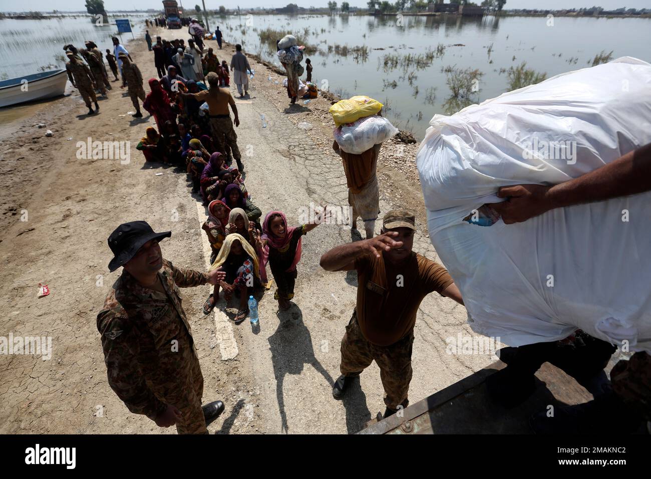 Aid is distributed to victims of heavy flooding from monsoon rains in ...