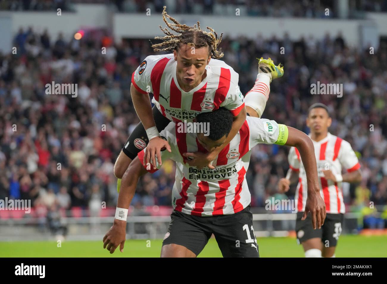 PSV's Xavi Simons jumps on the back of Cody Gakpo who scored his side's  first goal during the Europa League group A soccer match between PSV and  Bodo/Glimt at the Philips stadium