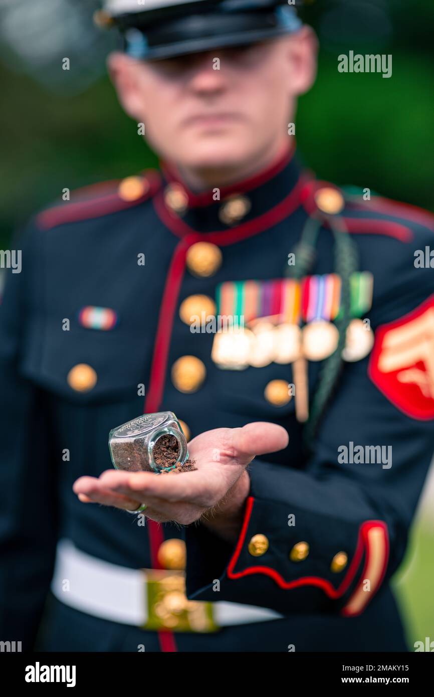 U.S. Marine Corps Cpl Sutton Rosencrantz, a Cleveland, Georgia native and  machine gunner with 6th Marine Regiment, 2d Marine Division, poses for a  photo holding sand from Omaha Beach after a ceremony