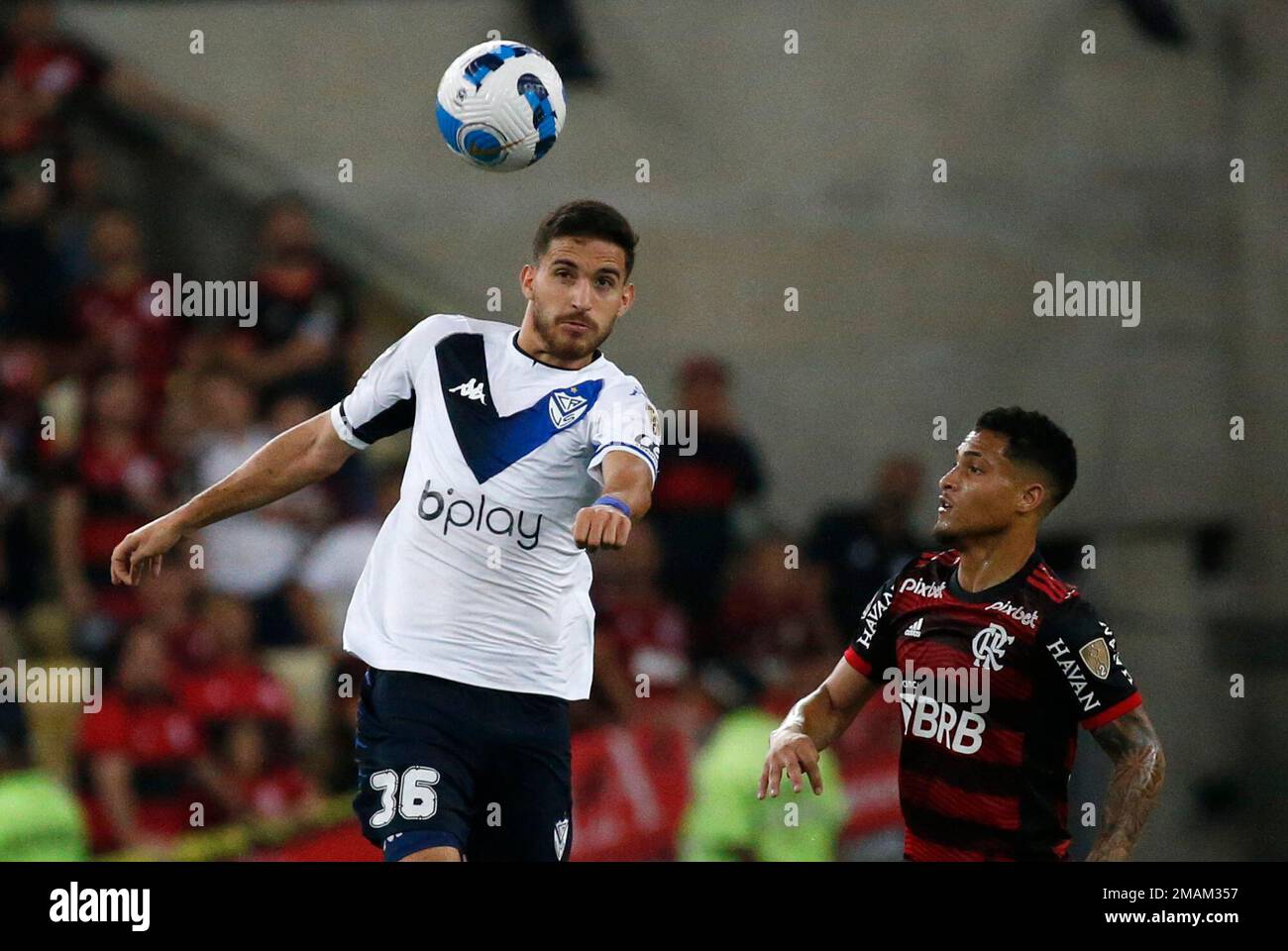 Nicolas Garayalde of Argentina's Velez Sarsfield, left, heads the ball as  Guillermo Varela of Brazil's Flamengo looks on during a Copa Libertadores  semifinal second leg soccer match at Maracana stadium in Rio