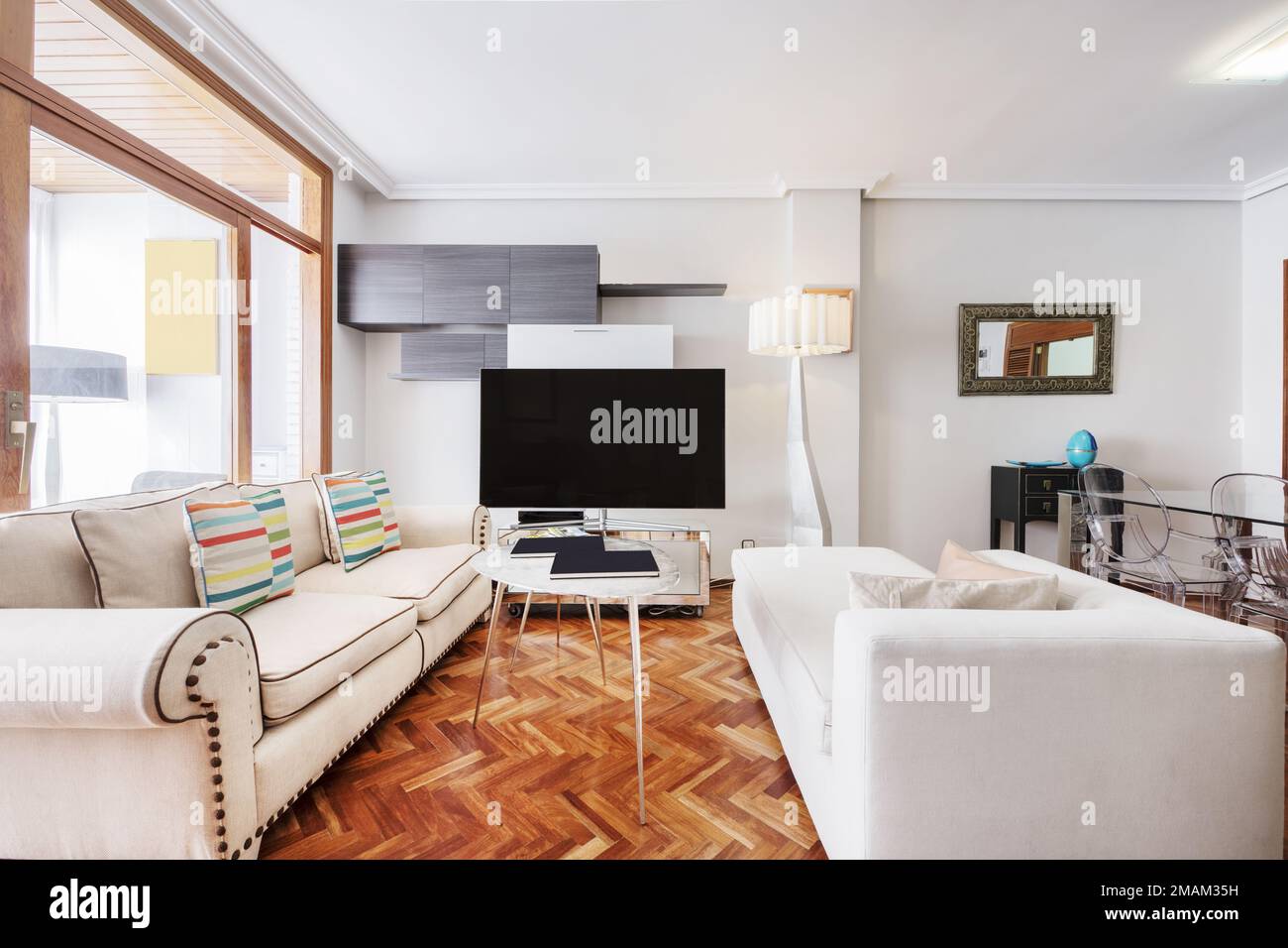 Apartment with a living room furnished with white sofas of various