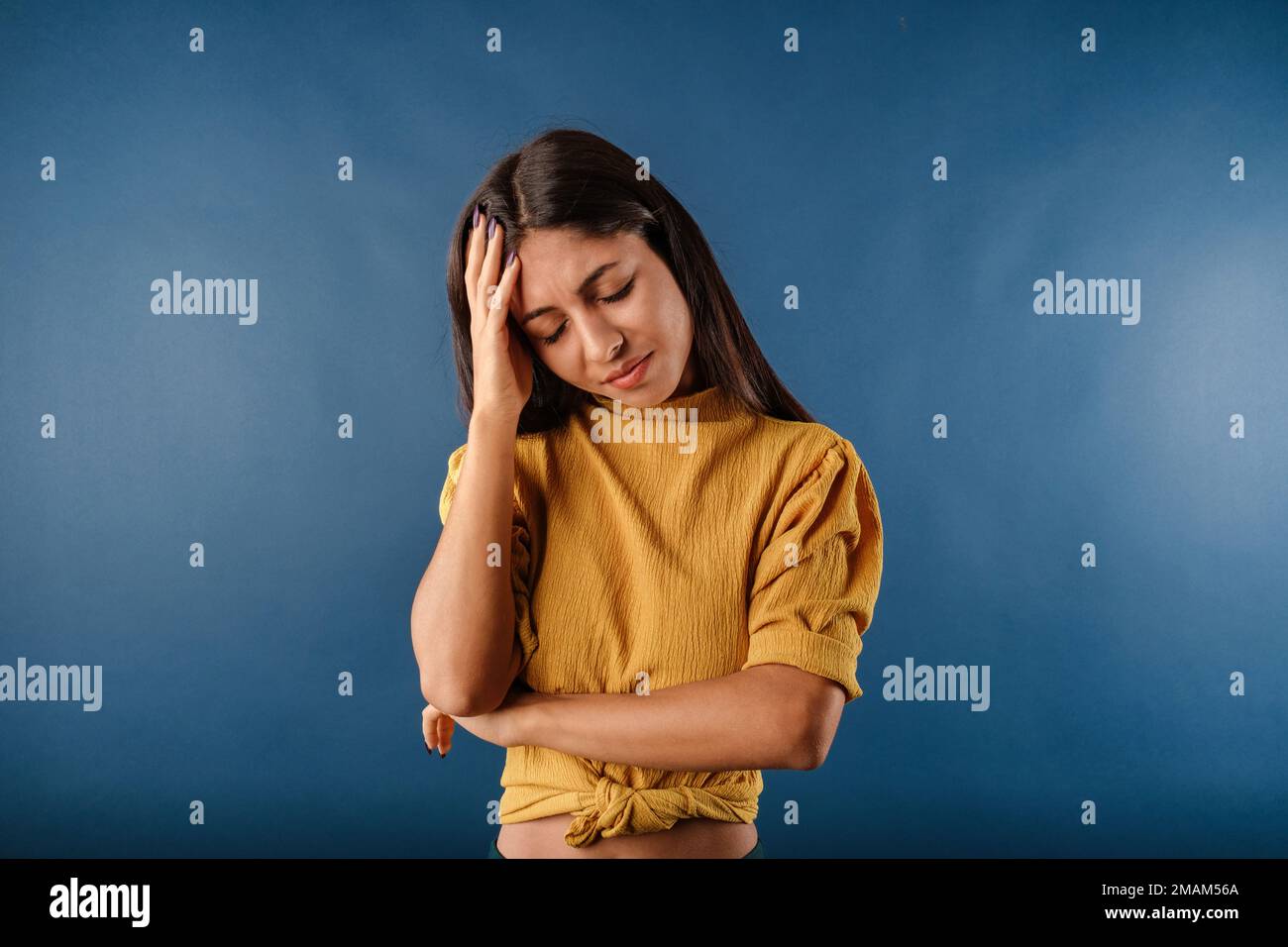 Beautiful woman wearing mustard yellow tshirt isolated over