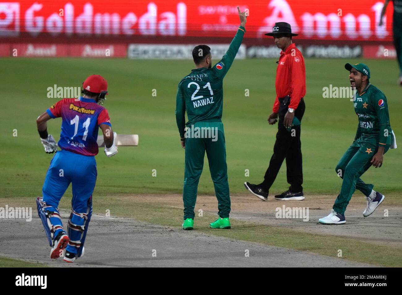 Pakistans Mohammad Nawaz, center, and captain Babar Azam, right, celebrate the dismissal of Afghanistans Karim Janat, left, during the T20 cricket match of Asia Cup between Pakistan and Afghanistan, in Sharjah, United