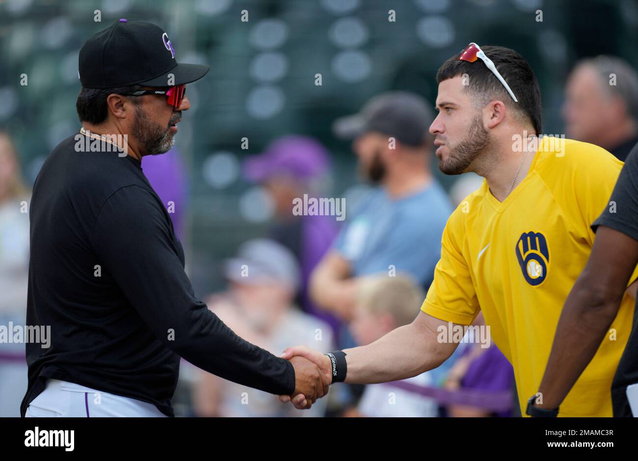 Vinny Castilla, left, special assistant to the general manager of the  Colorado Rockies, greets Chicago Cubs right fielder Carlos Gonzalez before  a baseball game Monday, June 10, 2019, in Denver. Gonzalez was