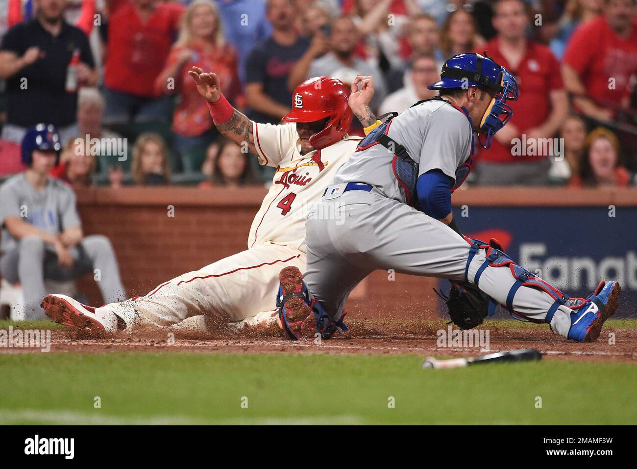 St. Louis Cardinals' Yadier Molina (4) is safe at home plate ahead of a tag  from Chicago Cubs catcher Yan Gomes (7) in the third inning of a baseball  game on Saturday