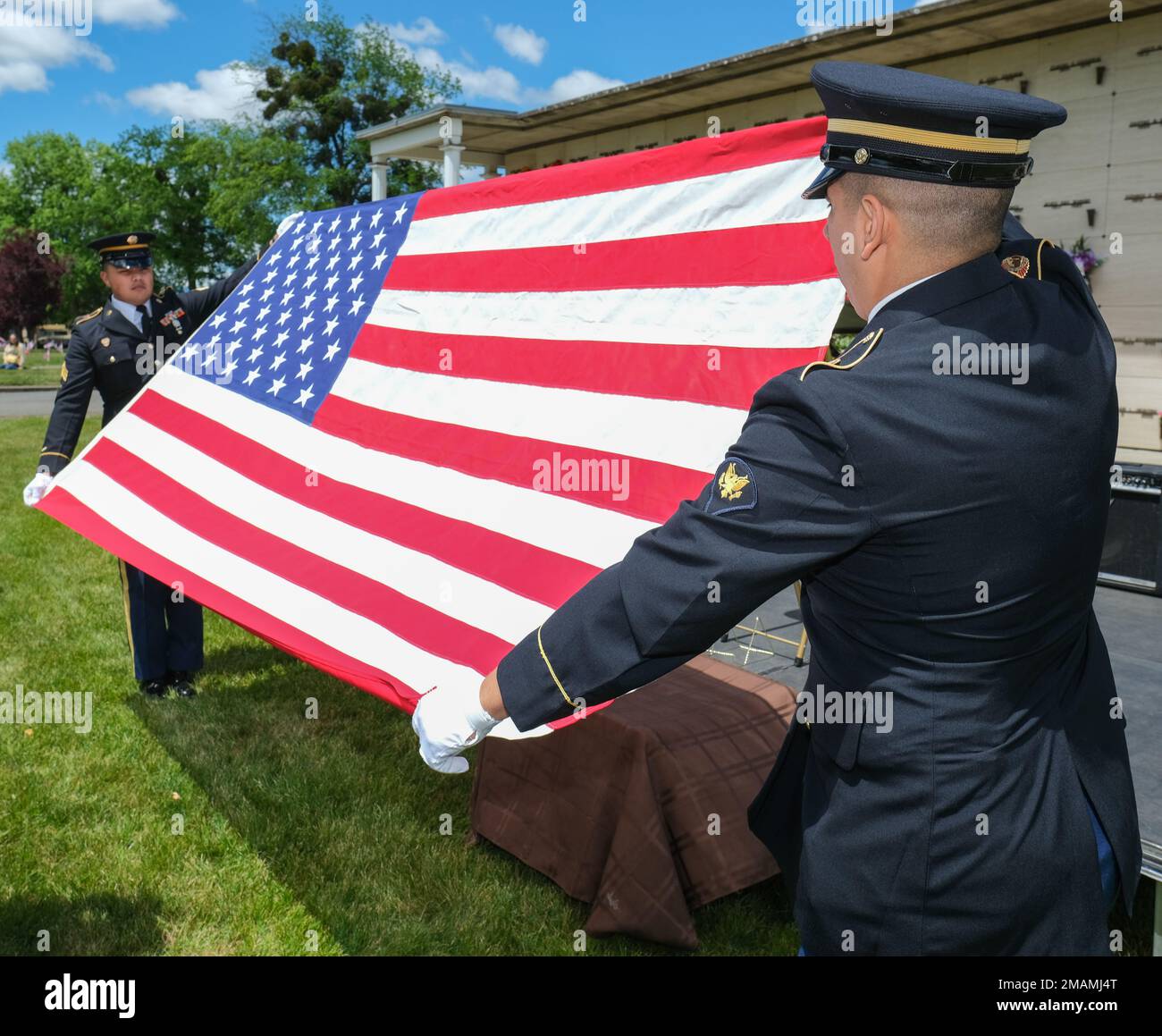 Two Oregon National Guard Funeral Honors Team members conduct a flag folding ceremony as part of a service at Hillcrest Memorial Park in Medford, Ore., on May 30, 2022. Stock Photo