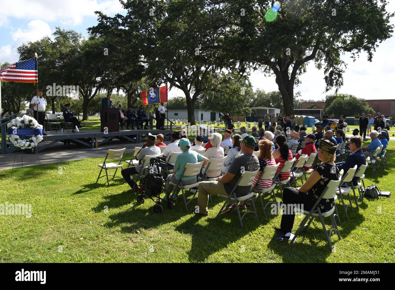 Local veterans and community members attend the Biloxi National Cemetery Memorial Day Ceremony in Biloxi, Mississippi, May 30, 2022. The ceremony honored those who have made the ultimate sacrifice while serving in the armed forces. Biloxi National Cemetery is the final resting place of more than 23,000 veterans and their family members. Every year, 800 burials take place there for men and women who served in wars years ago and for those defending America today. Stock Photo