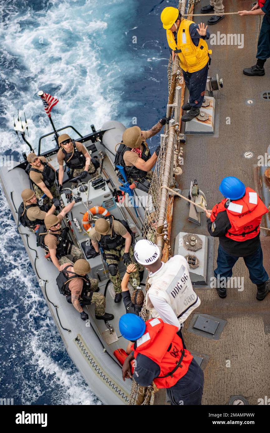 220530-N-XR893-2039 MEDITERRANEAN SEA (May 30, 2022) Sailors assigned to USS Bainbridge (DDG 96) climb down the pilot's ladder onto a rigid-hull inflatable-boat for a visit-board search and seizure exercise, May 30, 2022. Bainbridge is on a scheduled deployment in the U.S. Naval Forces Europe area of operations, employed by U.S. Sixth Fleet to defend U.S., Allied and Partner interests. Stock Photo