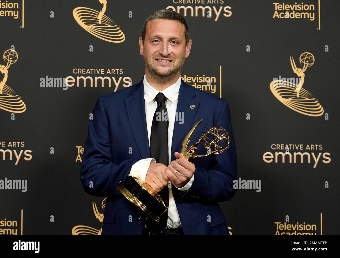 Tim Robinson poses in the press room with outstanding actor in a 