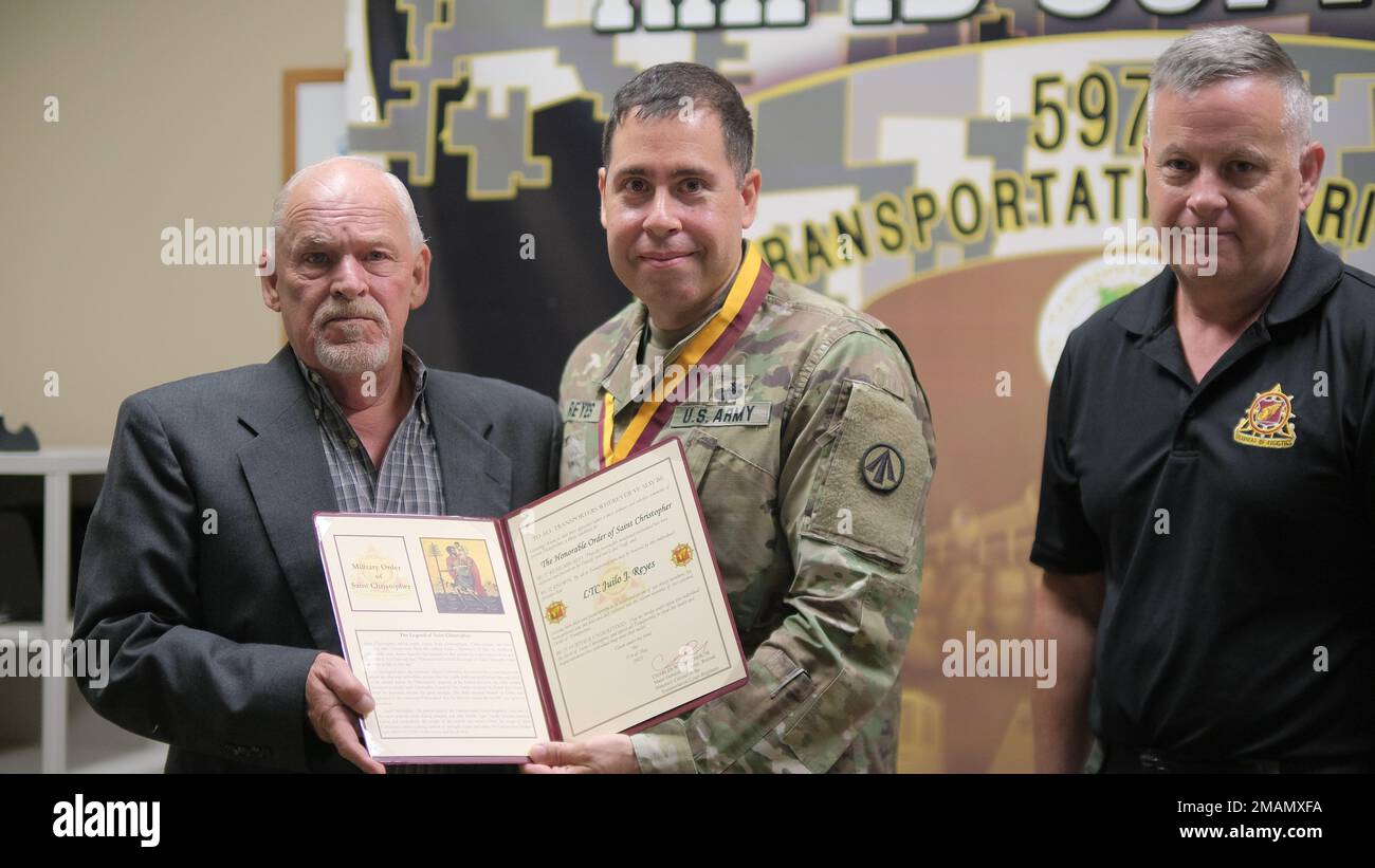 597th Transportation Brigade Operations Chief Lt. Col. Julio Reyes was presented with the Honorable Order of Saint Christopher award y Larry Lawrence and Gene Sullivan during a farewell get together at Joint Base Langley-Eustis, Va. May 31. Stock Photo