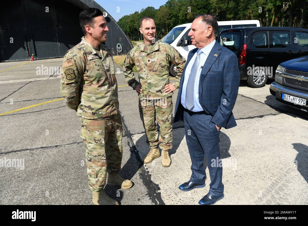 U.S. Air Force Lt. Col. Timothy Liebold, 701st Munitions Support Squadron commander (center), and Tech. Sgt. Sean Jarvis, 701st Munitions Support Squadron custody forces specialist, greet United States Ambassador to the Kingdom of Belgium Michael M. Adler, at Kleine Brogel Air Base, Belgium, on May 31, 2022. The custody forces team works hand in hand with their Belgian counterparts to maintain security and law enforcement on base. Stock Photo