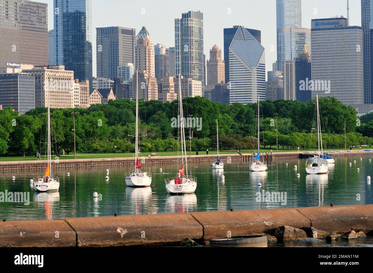 Chicago, Illinois, USA. Boats begin to fill Monroe Street and Burnham harbors inside a breakwater as owners anchor their crafts for the summer season. Stock Photo