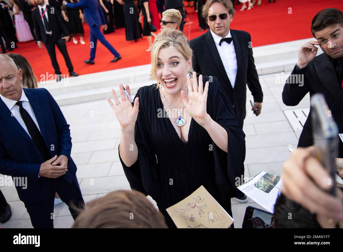Greta Gerwig signs autographs upon arrival at the premiere of the film