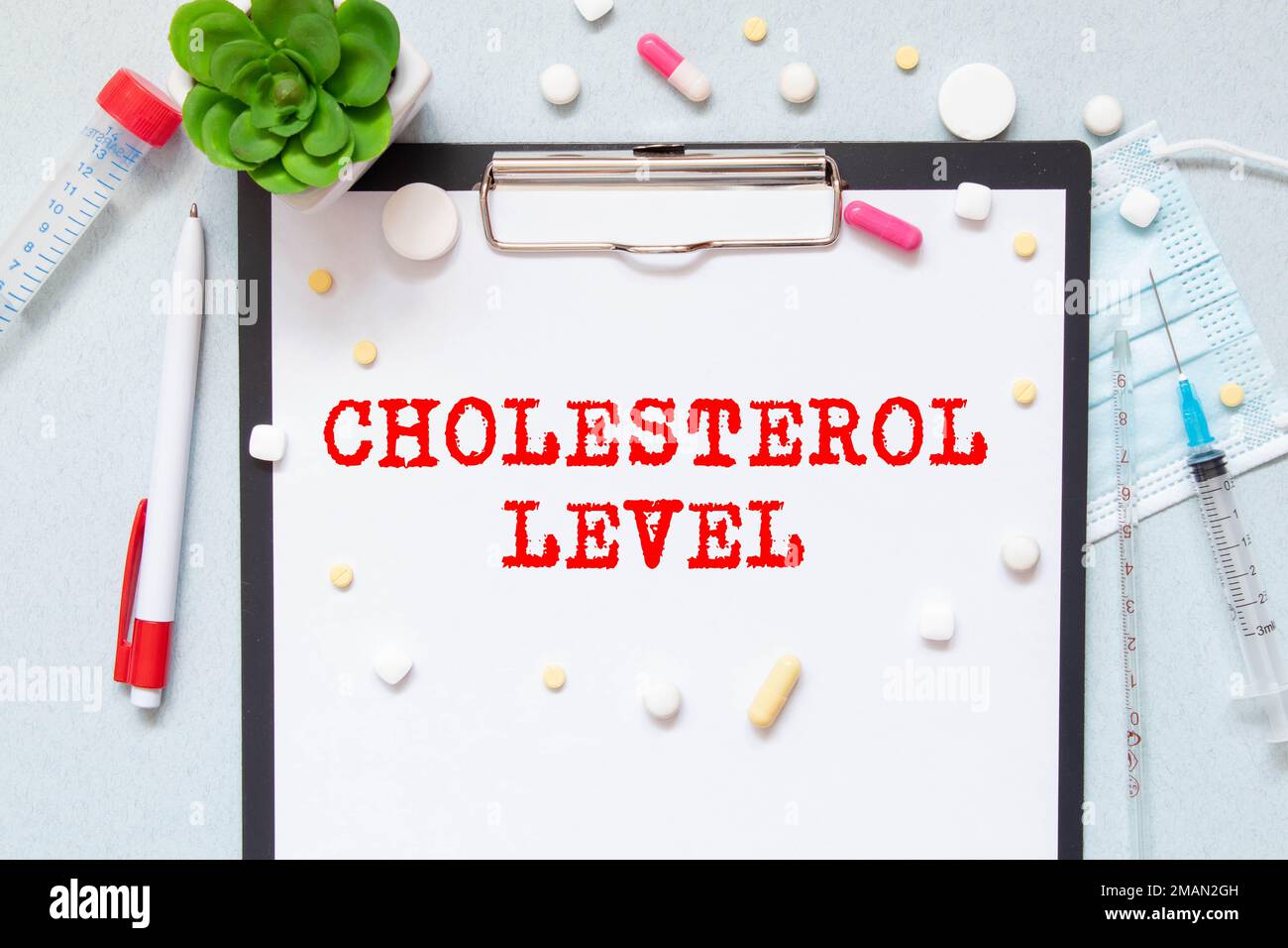 Cholesterol level text on a card clip to a sheet of notepad on a desk, business concept. Stock Photo