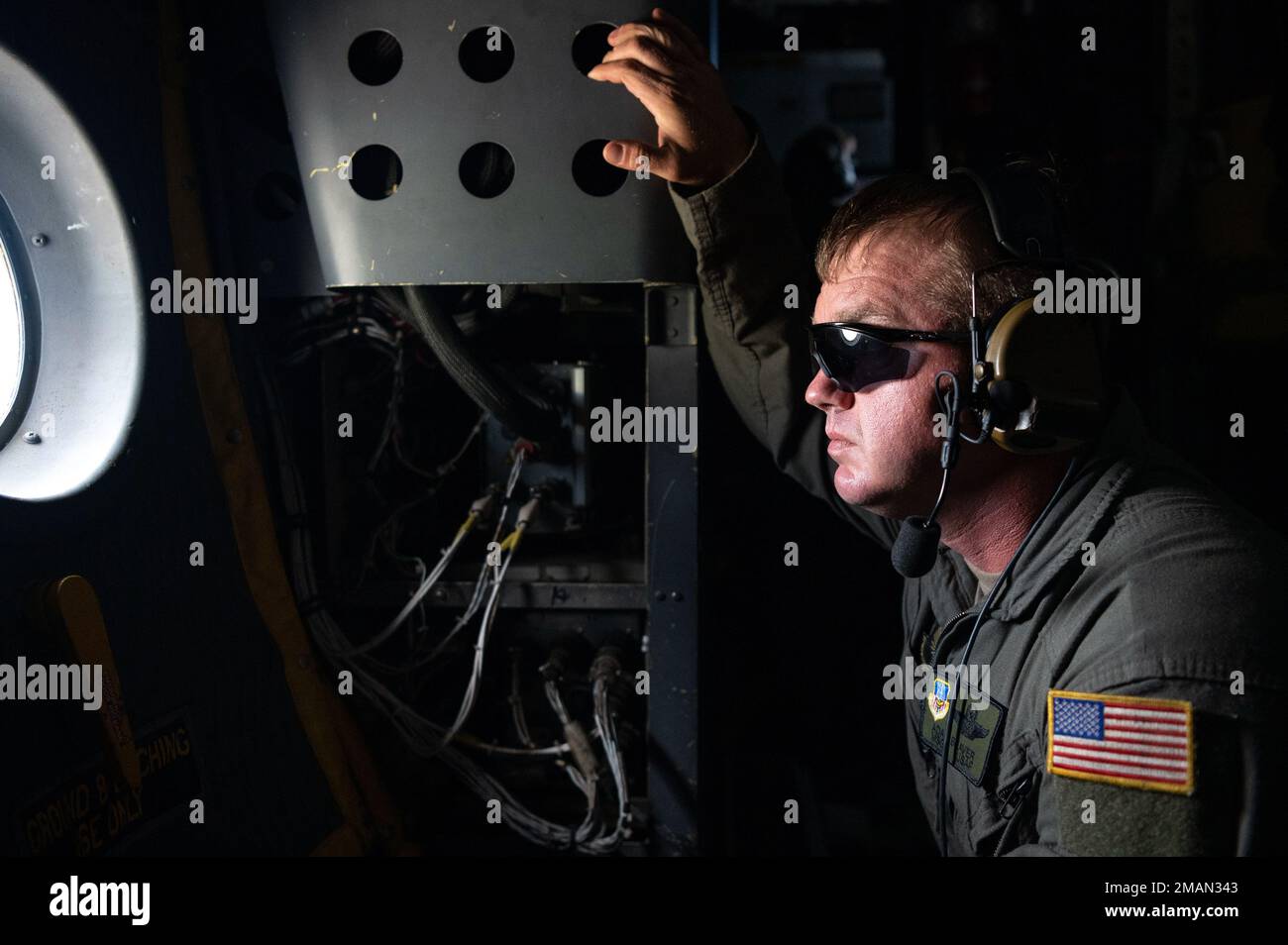 U.S. Air Force Master Sgt. Adam Beaver, the 19th Special Operations Squadron mobility section supervisor, looks out the window of an MC-130H Combat Talon II during its final flight under the 492nd Special Operations Wing at Hurlburt Field, Florida, May 31, 2022. The MC-130H has played a vital role in Air Force Special Operations Command operations, and its highlights include the evacuations of non-combatant Americans and other civilians from conflicts in Liberia in 1996. Stock Photo