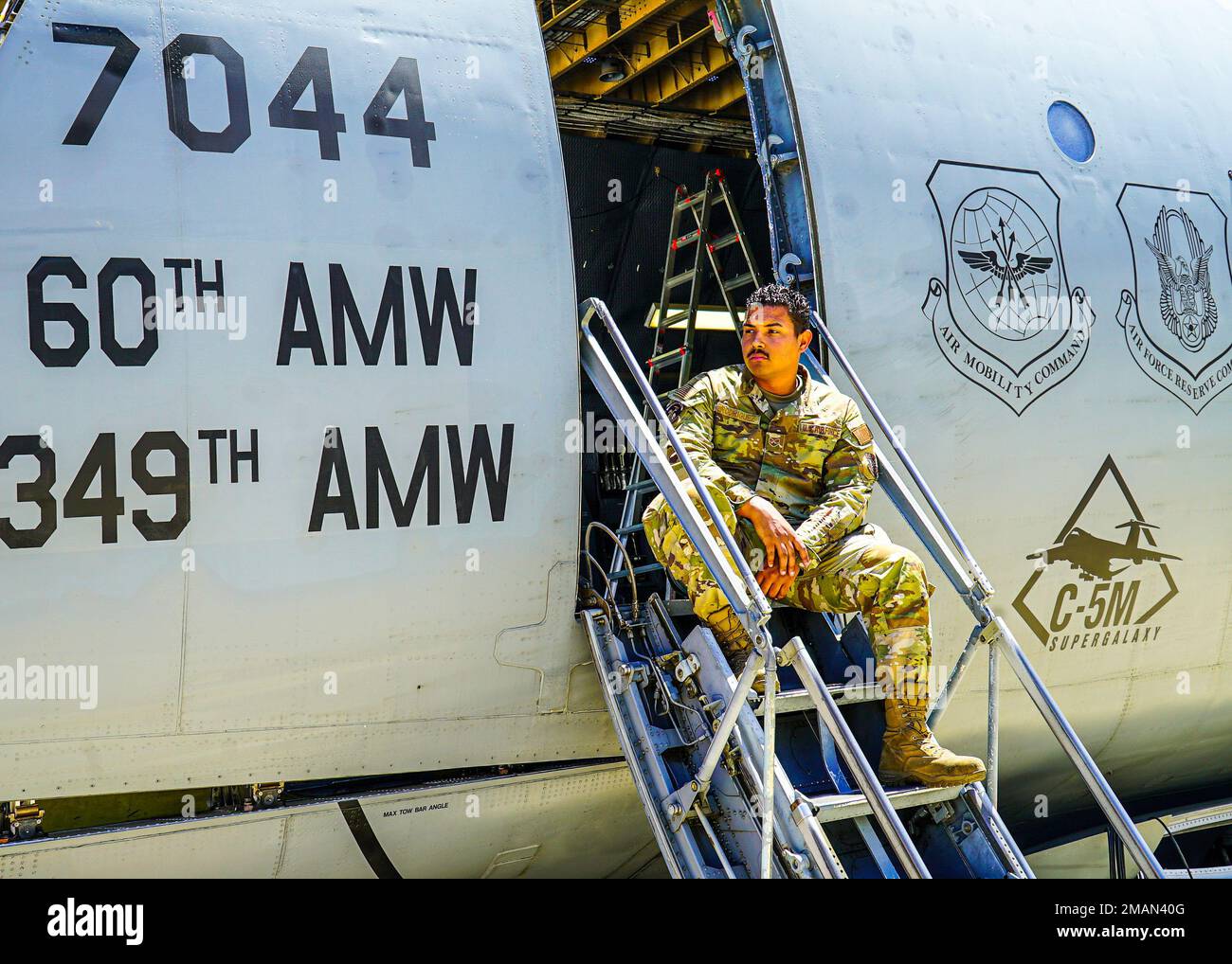 U.S. Air Force Staff Sgt. Louis Rodriguez, a C-5M Galaxy flying crew chief with the 60th Air Mobility Wing, observe the sixth Geosynchronous Earth Orbit Space Based Infrared System satellite (SBIRS GEO-6) loading into the C-5M Super Galaxy aircraft at Moffett Federal Airfield, Calif., May 31, 2022. The satellite was taken to a processing facility to undergo testing and fueling prior to encapsulation. GEO-6 is expected to launch in July 2022 and is the last SBIRS program launch. Stock Photo