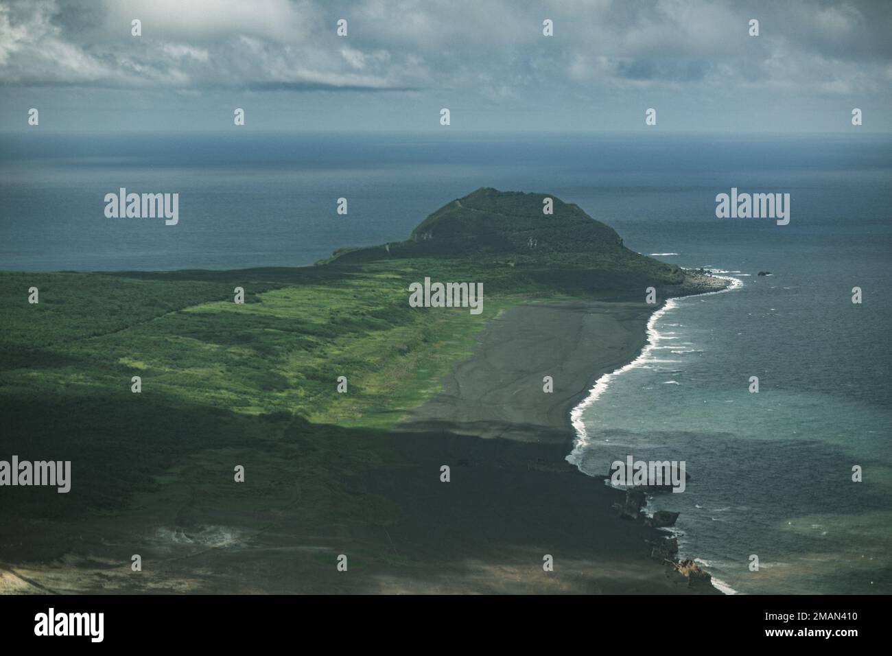 Waves crash into the volcanic ash beaches below Mt. Suribachi, Iō Tō ...