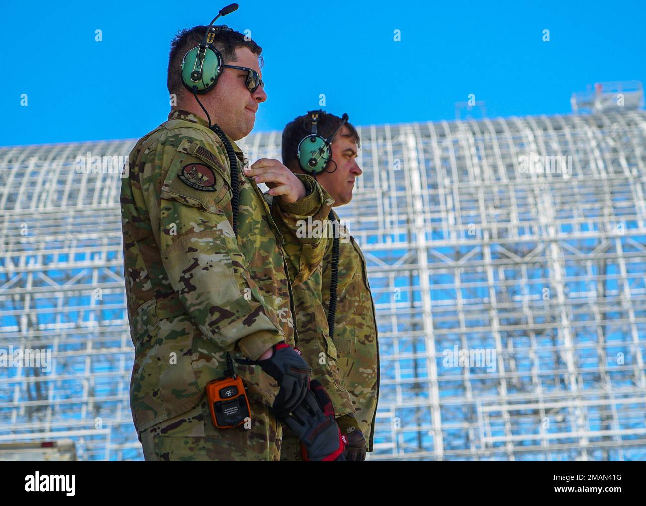 U.S. Air Force Tech. Sgt. Paul Sugarman (left) and Master Sgt. Adam Bailey (right), loadmasters with the 60th Air Mobility Wing, observe the sixth Geosynchronous Earth Orbit Space Based Infrared System satellite (SBIRS GEO-6) loading into the C-5M Super Galaxy aircraft at Moffett Federal Airfield, Calif., May 31, 2022. The satellite was taken to a processing facility to undergo testing and fueling prior to encapsulation. GEO-6 is expected to launch in July 2022 and is the last SBIRS program launch. Stock Photo