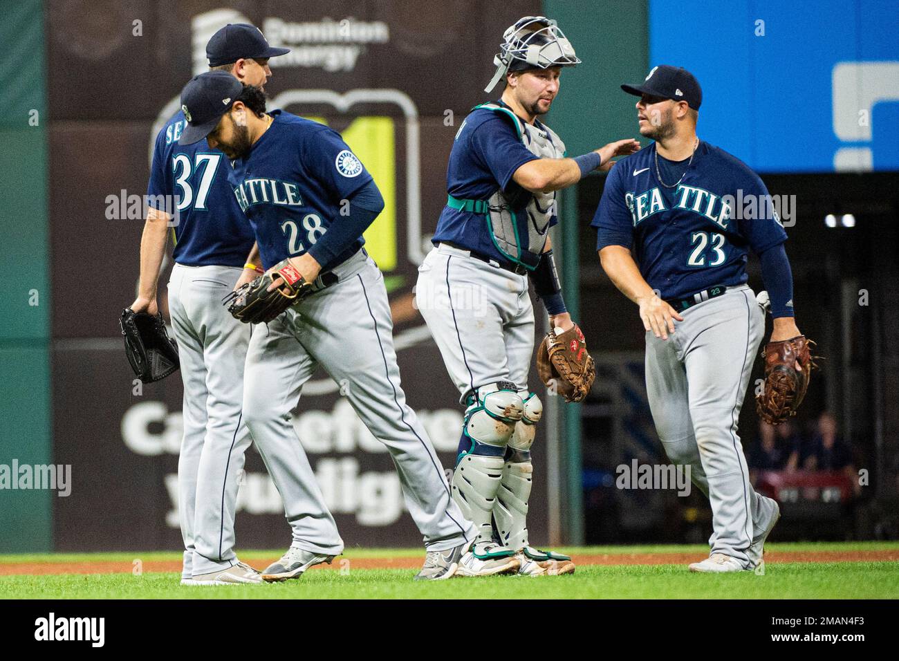 Seattle Mariners catcher Cal Raleigh congratulates Ty France (23) as