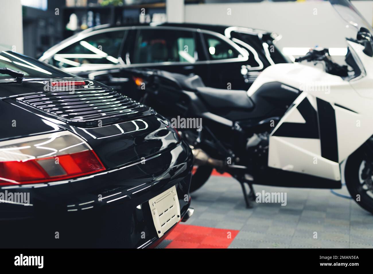 Interior of a car detailing studio. Black sports car ready for