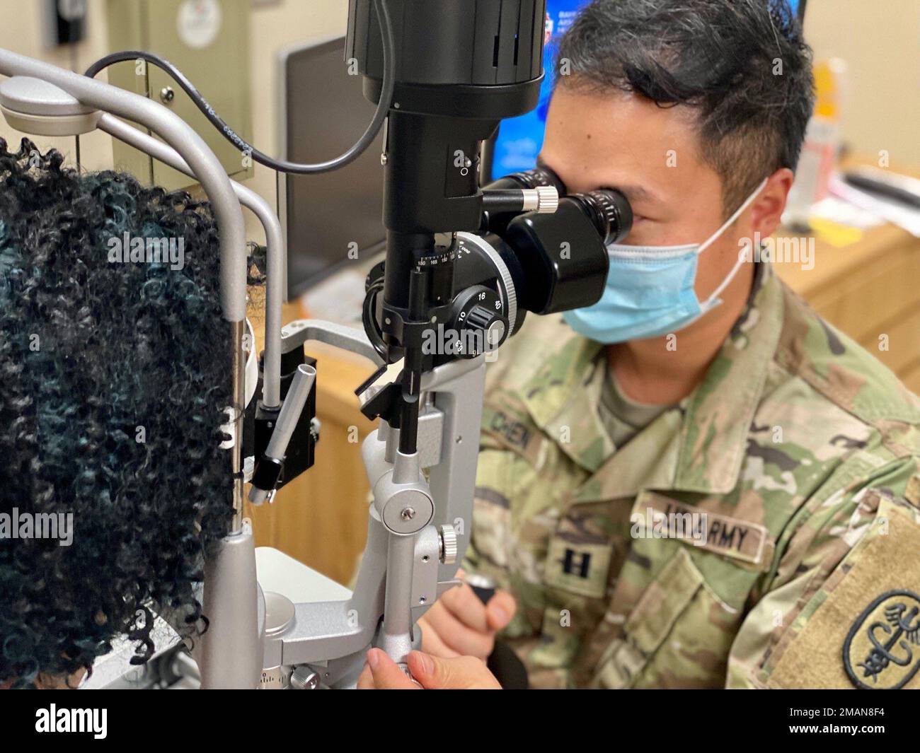 Capt. Yuhang Chen, an optometrist in the Bayne-Jones Army Community Hospital Ears, Eyes, Nose and Throat clinic conducts an exam at the Joint Readiness Training Center and Fort Polk, Louisiana. Stock Photo