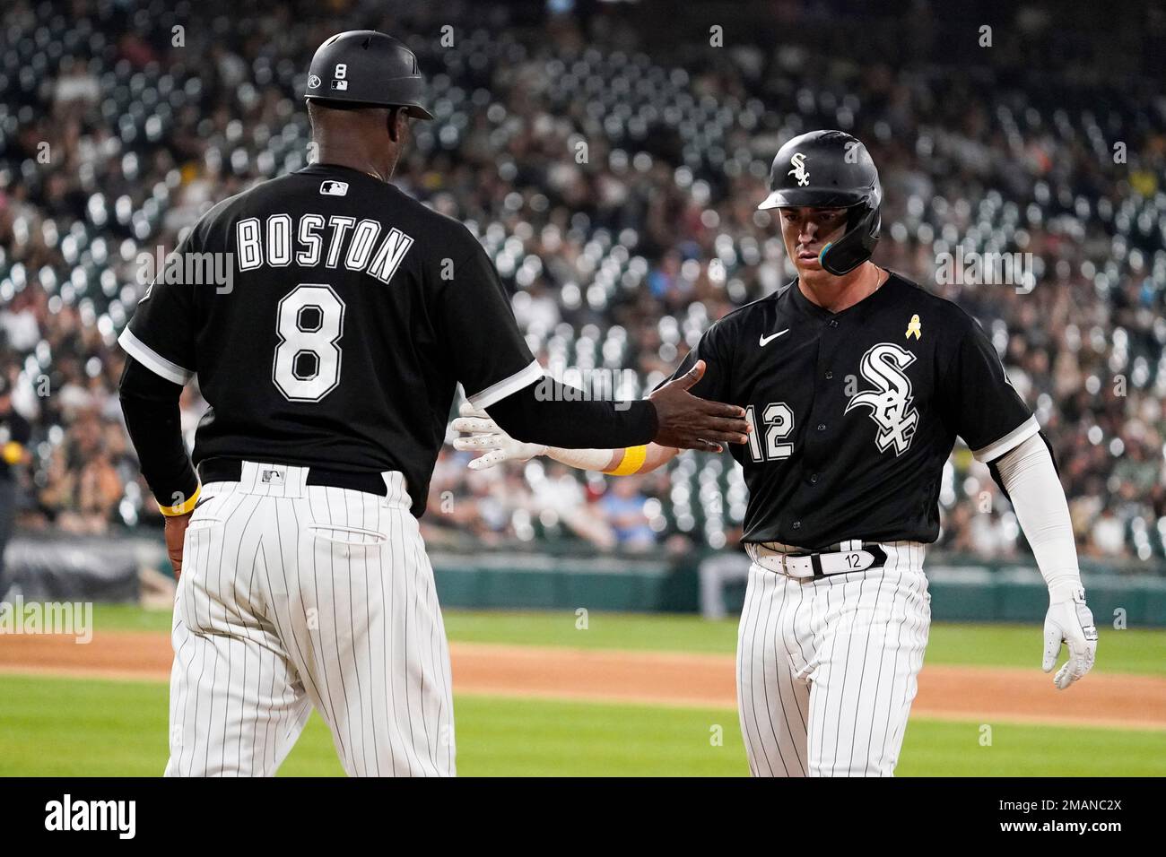 Chicago White Sox's Romy Gonzalez, right, celebrates with first base coach  Daryl Boston after hitting a single during the ninth inning of the team's  baseball game against the Minnesota Twins in Chicago