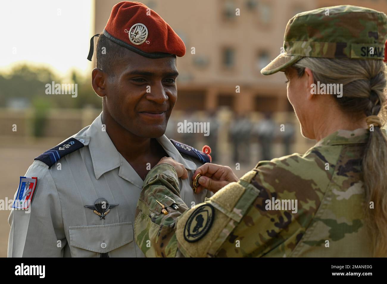 U.S. Army Maj. Gen. Jami Shawley, commanding general of Combined Joint Task Force - Horn of Africa (CJTF-HOA), pins a desert commando badge on a French soldier during a French Desert Commando Course graduation ceremony at the 5th Overseas Interarms Regiment, Djibouti, June 1, 2022. Members of the CJTF-HOA regularly train and work alongside allies, partners, and government organizations to achieve a unified effort to improve safety, security and prosperity in East Africa. Stock Photo