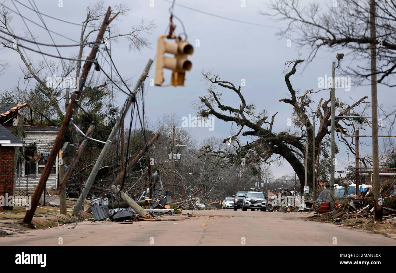 Cars carefully navigate around downed trees and power lines on Chestnut