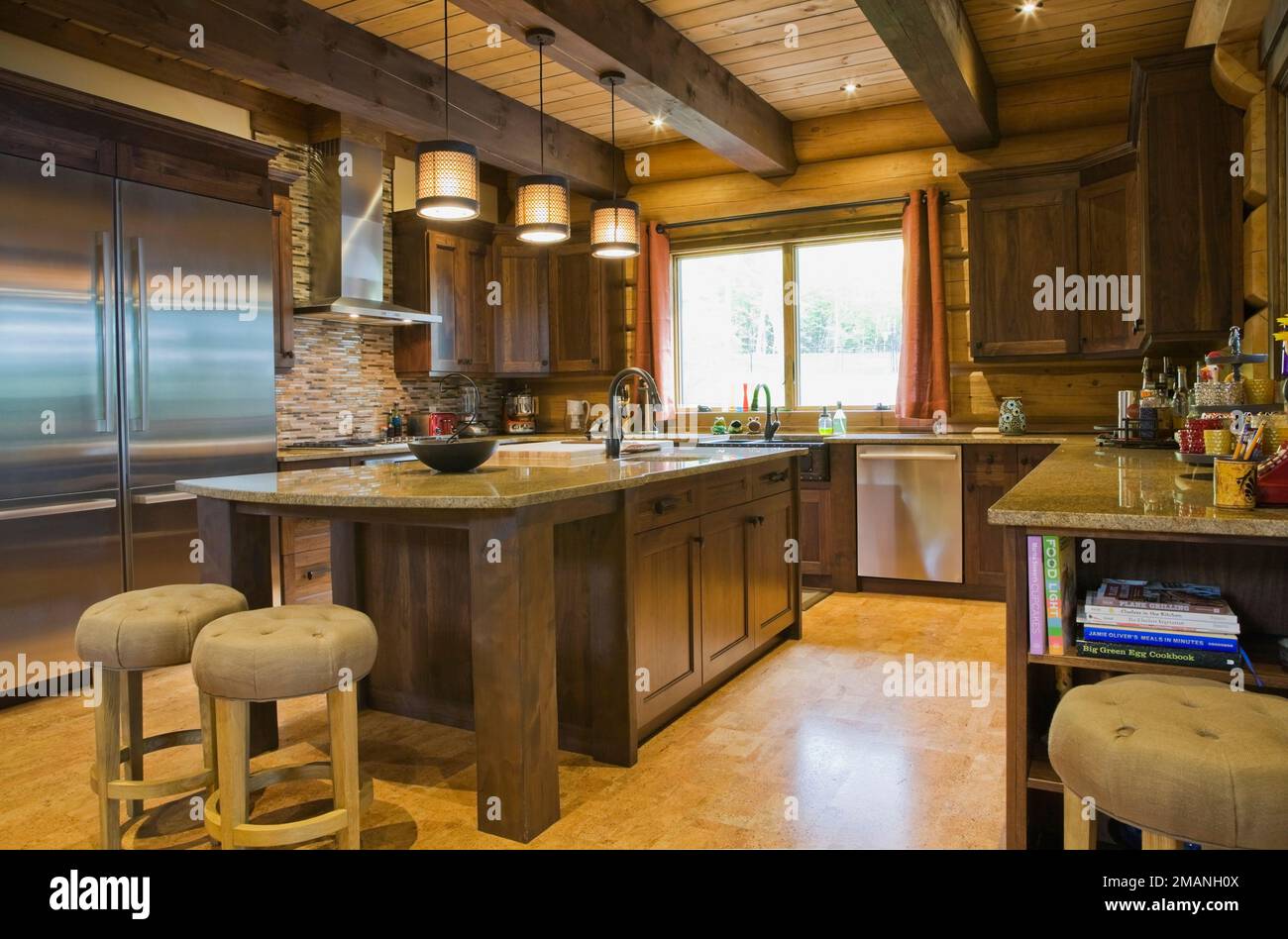 Brown stained pine wood island with granite countertop, sand coloured ...